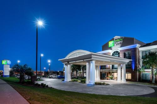 a gas station in front of a building at night at Holiday Inn Express & Suites Florence I-95 & I-20 Civic Ctr by IHG in Florence