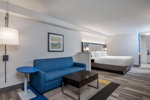 a hotel room with a couch and a bed at Holiday Inn Express & Suites Florence I-95 & I-20 Civic Ctr by IHG in Florence