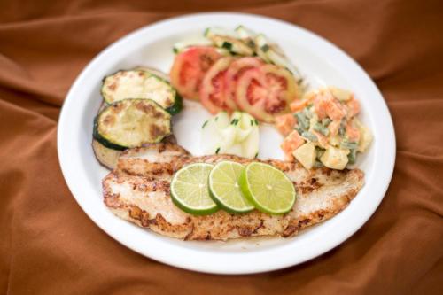 a plate of food with bread and vegetables on a table at Hotel Tikal Inn in Tikal