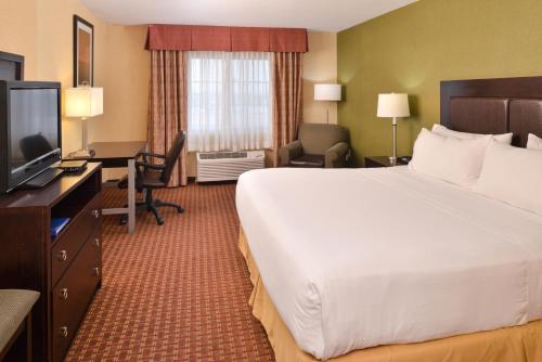 a hotel room with a bed and a desk and a television at Holiday Inn Express Hotel & Suites El Centro by IHG in El Centro