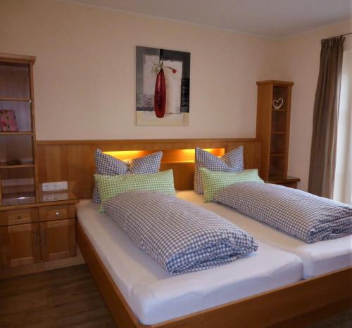 1 dormitorio con 1 cama con almohadas azules y blancas en Alpenflair Ferienwohnungen Whg 301 en Oberstdorf