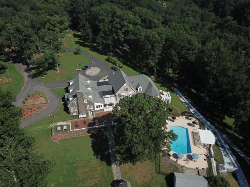 an aerial view of a large house with a swimming pool at The Manor at Courtland Farm in Aldie