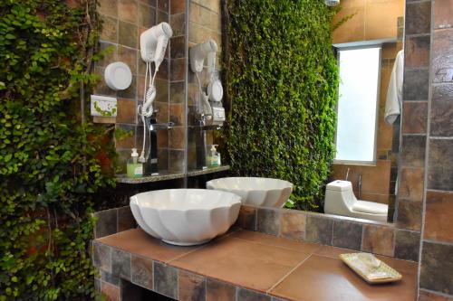 a bathroom with two sinks and a green wall at Design House Corrientes in Corrientes