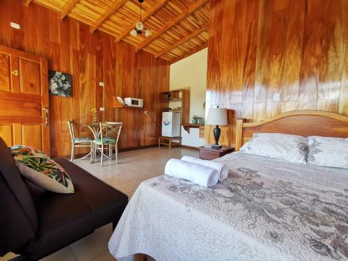 a bedroom with a bed and a couch and a table at Apartment Monte Luna Mountain View in Monteverde Costa Rica