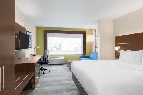 a hotel room with a large bed and a desk at Holiday Inn Express & Suites - Union Gap - Yakima Area by IHG in Union Gap