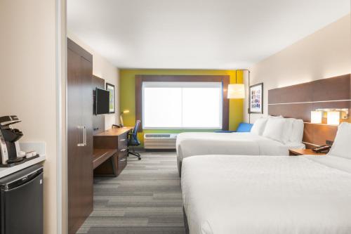 a hotel room with two beds and a desk at Holiday Inn Express & Suites - Union Gap - Yakima Area by IHG in Union Gap