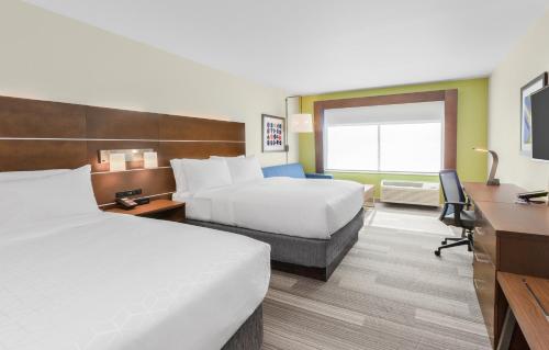 a hotel room with two beds and a desk at Holiday Inn Express & Suites - Union Gap - Yakima Area by IHG in Union Gap