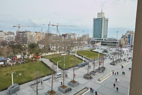 a view of a city with people walking around a park at Great View of Taksim Square, Luxury Furnished on Main Street of Taksim, Partial Sea View in Istanbul