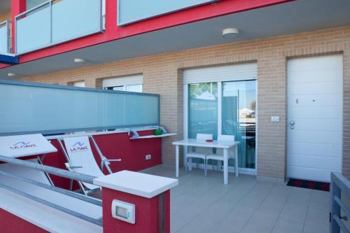a balcony of a building with a table and a bench at Residence La Nave in Senigallia