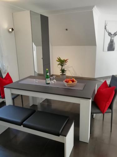 a table with two chairs and a bowl of fruit on it at Waldhotel Forsthaus Remstecken in Koblenz