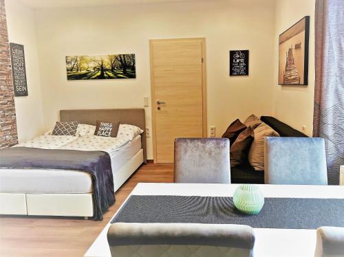 a room with two beds and a table and chairs at Apartment Sonne in Waidhofen an der Thaya