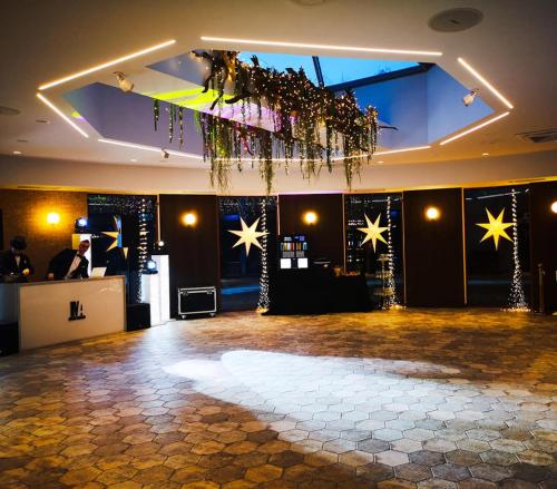 a large room with a dance floor with stars on the wall at Leśne Patio in Katowice