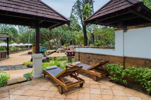 a patio with tables and chairs and a pavilion at JW Marriott Phuket Resort and Spa in Mai Khao Beach
