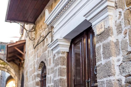 a door on a brick building with a sign on it at CASA DI ALEJANDRO in Rhodes Town