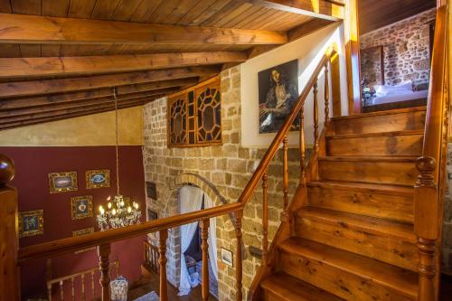 a staircase in a house with a stone fireplace at CASA DI ALEJANDRO in Rhodes Town