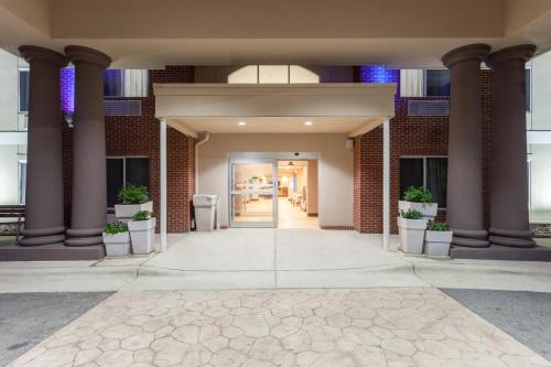 an entrance to a building with columns and a hallway at Holiday Inn Express Hotel & Suites Mebane by IHG in Mebane
