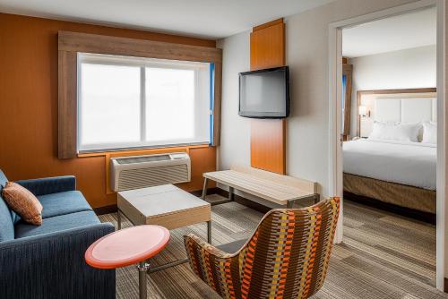 a hotel room with a couch and a bed at Holiday Inn Express & Suites Halifax - Bedford by IHG in Halifax
