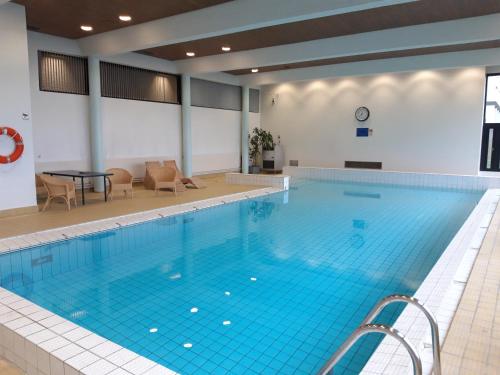 a large swimming pool in a building at Hämeenkylän Kartano in Vantaa