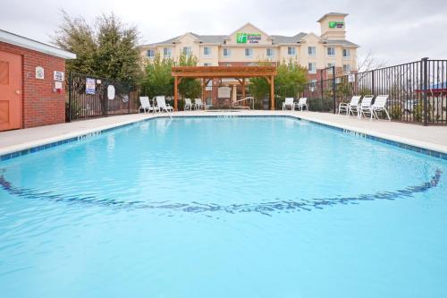 a swimming pool with a pool table in front of it at Holiday Inn Express Hotel & Suites Dallas - Grand Prairie I-20, an IHG Hotel in Grand Prairie