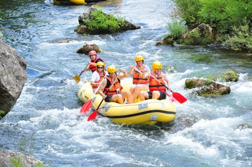a group of people in a raft on a river at Hotel Villa Dvor in Omiš