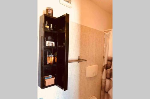 a bathroom with a black shelf on the wall at Casa Pierina in Anacapri