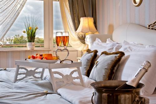 a bed with a table with a bowl of fruit on it at Mozart Hotel in Krasnodar