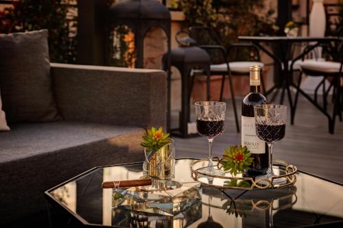 
a table with a glass of wine and a plate of food at Dharma Boutique Hotel & SPA in Rome
