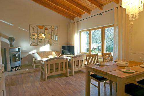 a living room with a wooden table and a dining room at Harzer Feriengarten in Quedlinburg