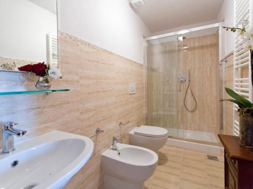 a bathroom with a sink and a toilet and a shower at Palazzo Piccolomini in Siena