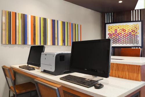 a desk with a computer and a printer on it at Holiday Inn Express & Suites Edinburg- Mcallen Area by IHG in Edinburg