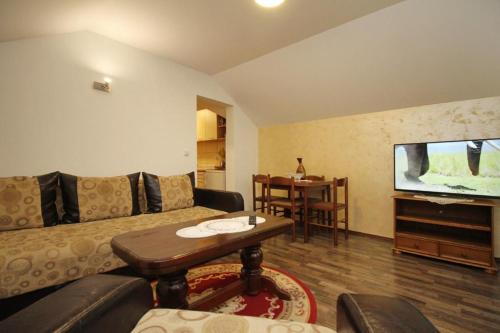 a living room with a couch and a table at Apartmani Bogdanović in Zlatibor