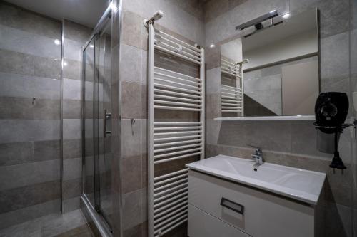 a bathroom with a sink and a shower at Apartments Big Smile in Zagreb