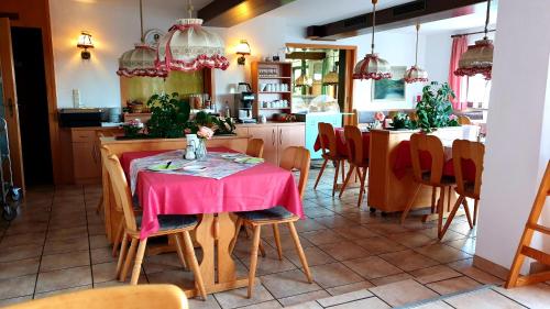 a dining room with a table with a pink table cloth at Landgasthof Traube in Heidenheim an der Brenz