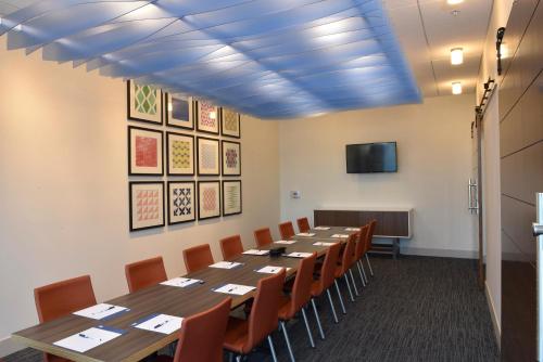 a conference room with a long table and chairs at Holiday Inn Express & Suites - Orlando - Southeast by IHG in Orlando