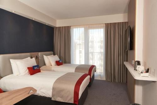 Кровать или кровати в номере Holiday Inn Express Amsterdam - City Hall by IHG