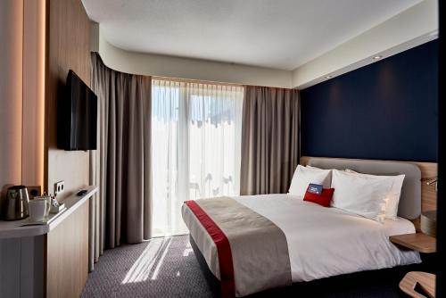 Кровать или кровати в номере Holiday Inn Express Amsterdam - City Hall by IHG