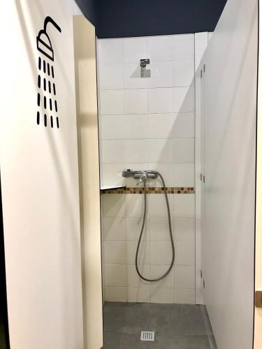 a bathroom with a shower with a shower curtain at Albergue O Burgo in O Pedrouzo