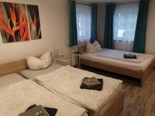 a room with two beds and a couch at Haus Pucher in Sankt Florian am Inn