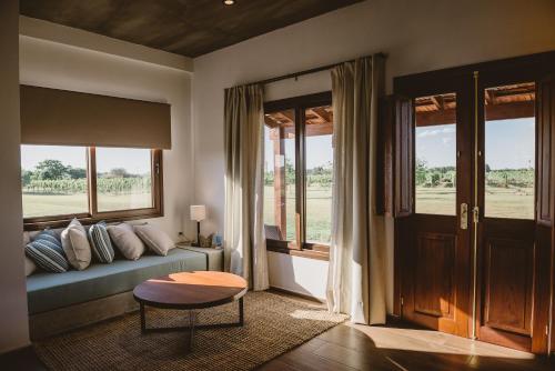 a living room with a couch and a window at El Legado Wine Lodge in Carmelo