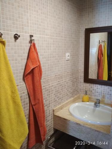 a bathroom with a sink and a mirror at El Cotillo Casa Checa 4 in El Cotillo