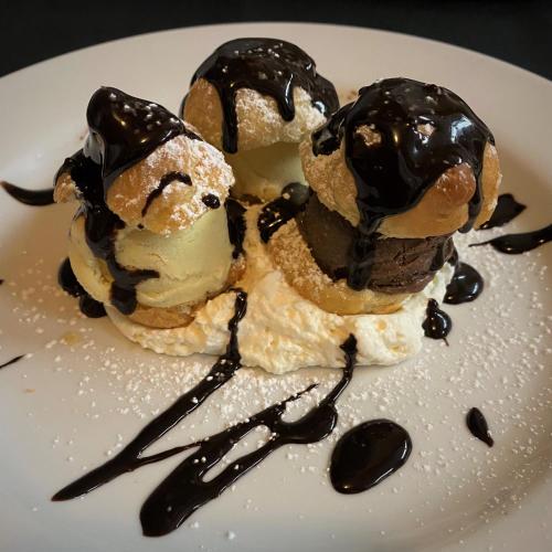 two ice cream scoops on a plate with chocolate sauce at The La Conner Inn in La Conner