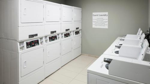 a laboratory with white appliances in a white room at Holiday Inn Express & Suites - Orlando At Seaworld, an IHG Hotel in Orlando