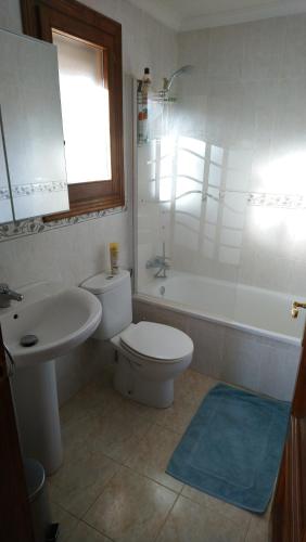 a bathroom with a toilet and a tub and a sink at Lovely villa with wonderful views in Pego