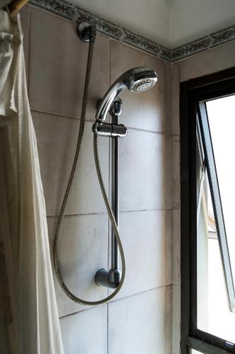 a shower in a bathroom with a shower head at Las Tejas in Córdoba