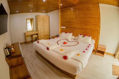 a bedroom with a large bed with flowers on it at PERLA Dhangethi in Dhangethi