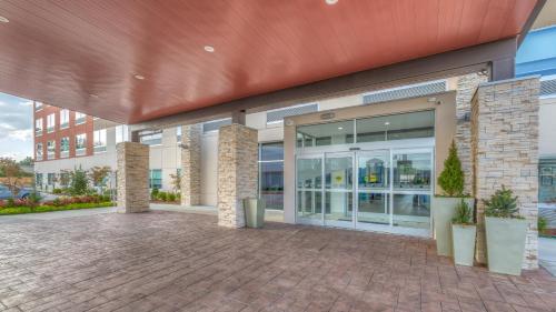 an office building with a large glass door at Holiday Inn Express & Suites Tulsa Midtown by IHG in Tulsa