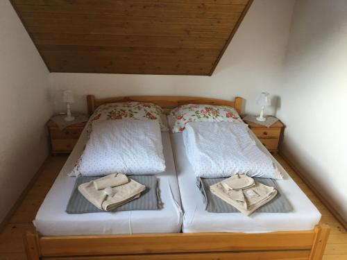 a bedroom with two beds with towels on them at Drevenica Jánošík 1 in Terchová