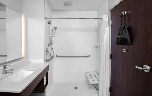 a white bathroom with a sink and a shower at Holiday Inn Express Hotel & Suites Altoona-Des Moines, an IHG Hotel in Altoona