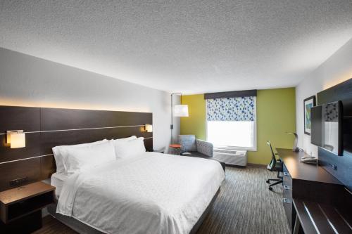 a hotel room with a bed and a television at Holiday Inn Express Hotel & Suites Altoona-Des Moines by IHG in Altoona
