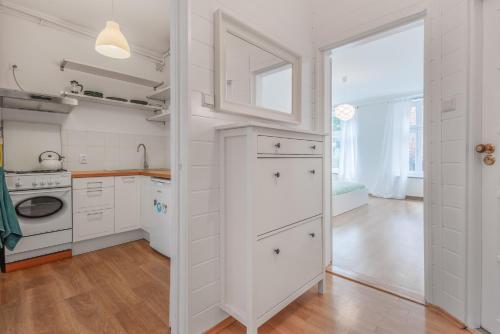 a kitchen with white cabinets and a large window at CITYSTAY Plac Walowy Gdansk in Gdańsk
